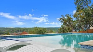 A swimming pool with a view of a hilly landscape. - Overlook Oasis-Stunning Views-Pool and Spa! (Austin)