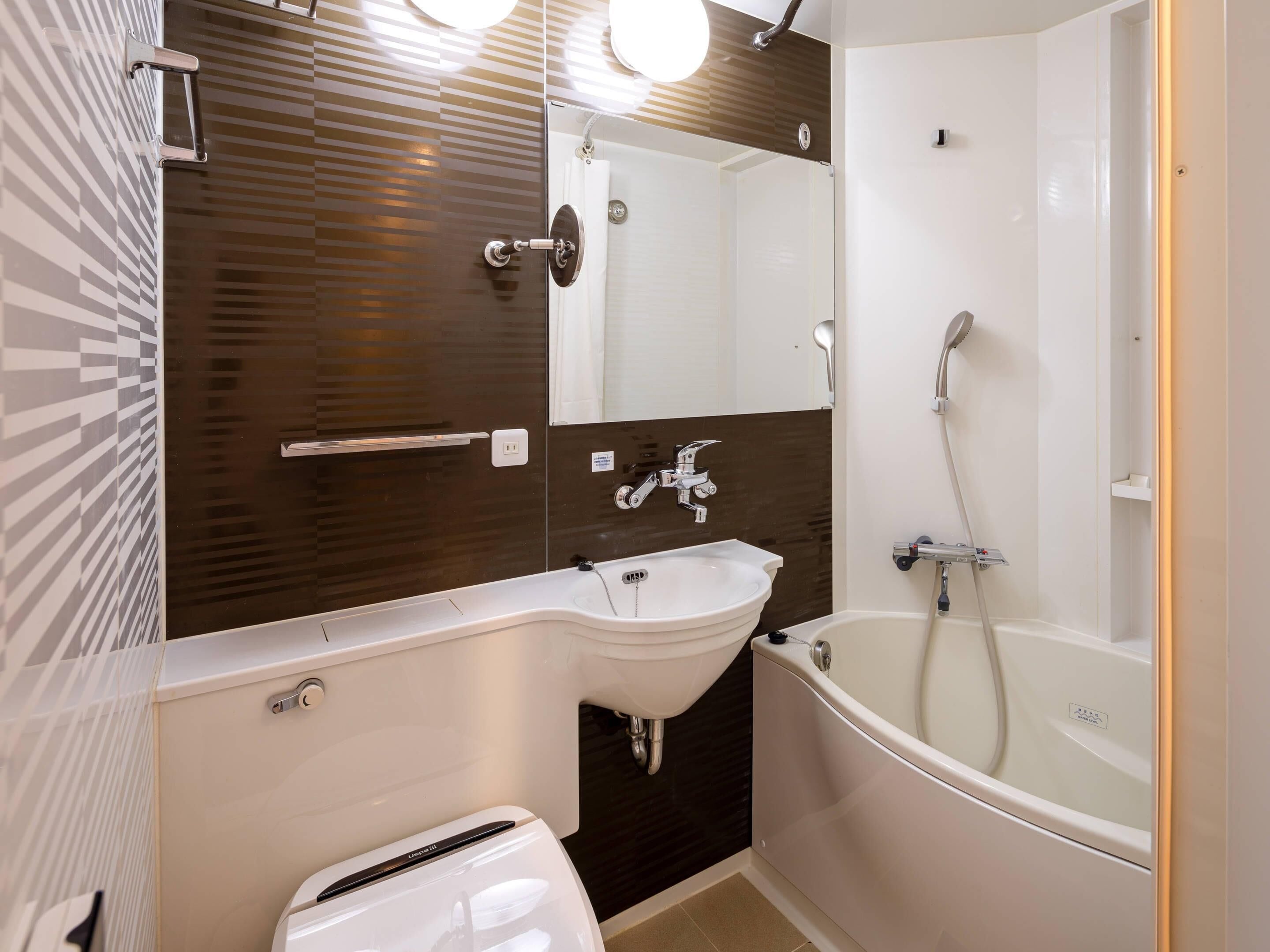 A modern bathroom with a white sink, a bathtub, and a mirror above the sink.