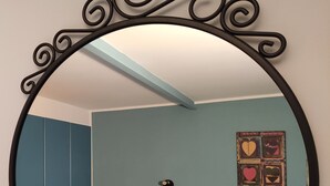 A bedroom with a bed, a wardrobe, and a wall-mounted light fixture. - The Arena - Apartment in the Center. Ideal for sightseeing. Metro 100m away (Napoli)