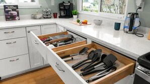 A kitchen with white cabinets, a coffee maker, a kettle, and a book titled "Arts of Baking". - Pool/Hot Tub/75 inch TV/1000mbps/Brand New (Grants Pass)