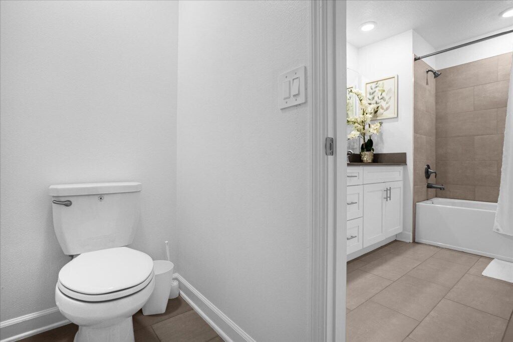A bathroom with a toilet, a sink, a shower, and a bathtub.