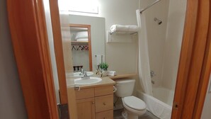 A bathroom with a wooden vanity, sink, and toilet. - Enjoy Serenity & Relax in 1BR/BA w/ Mountain View, 10 minutes drive to Banff  (Canmore)