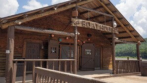 A rustic wooden building with a sign reading 'The Boat House.' - Ski-In Ski-Out•Hot Tub•King Bed•Sauna•Deck (Snowshoe)