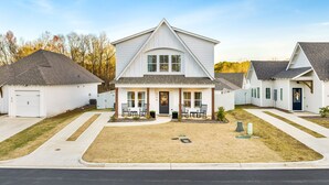 A single-story house with a front porch, a garage, and a small front yard.
