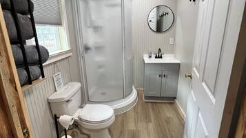 Shower, towels, soap, toilet paper