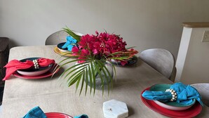 A dining table set with plates, napkins, and a centerpiece. - Island Oasis, Near Magens Bay Beach with Back-Up Power System (Charlotte Amalie)