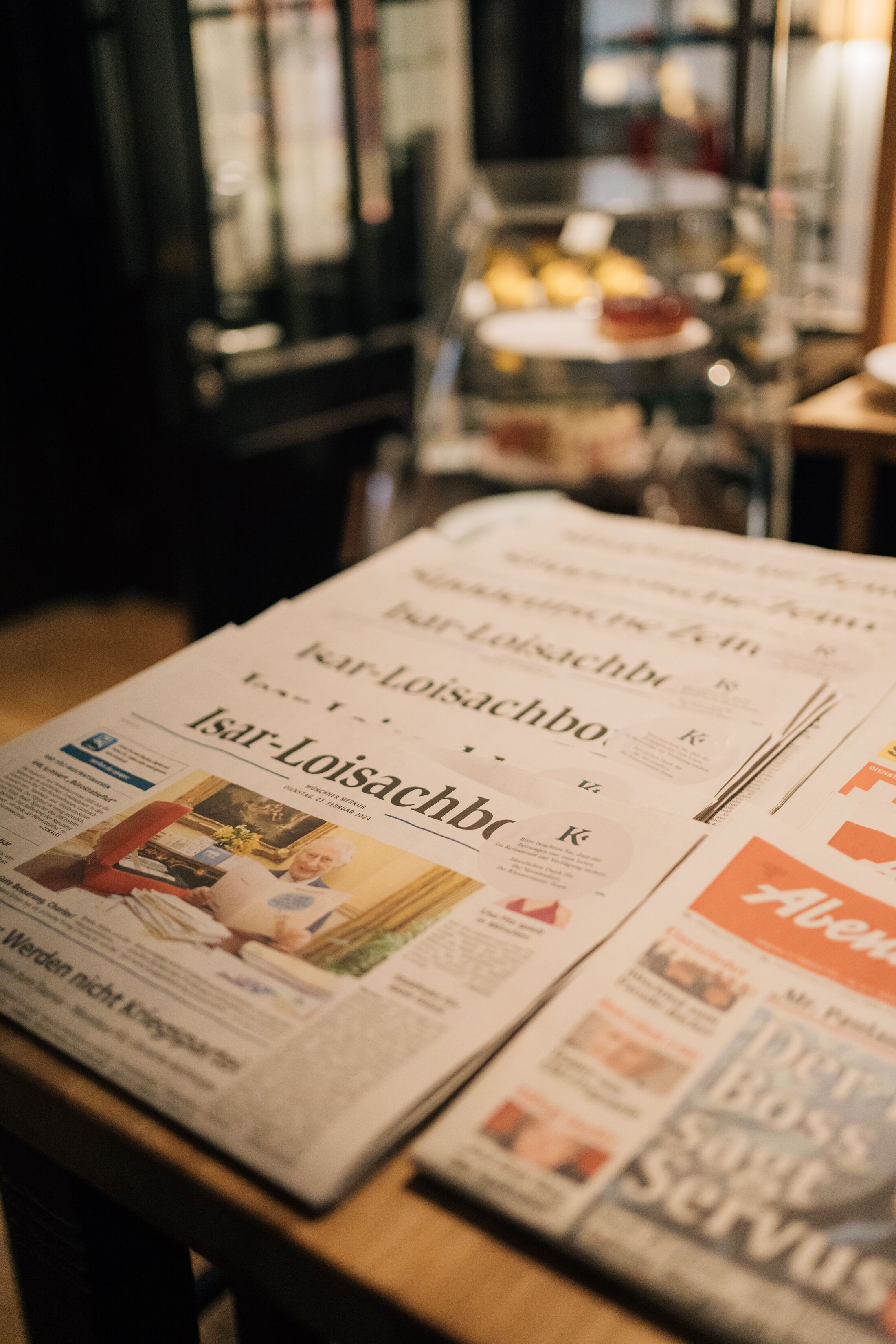 A newspaper on a table with visible headlines and articles.