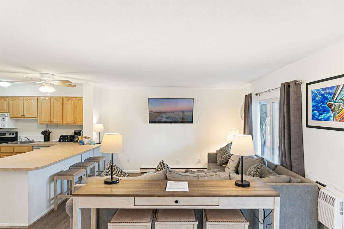 A modern living space with a kitchen, dining area, and seating area.