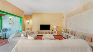 A hotel room with a bed, a TV, a small table, and a sofa. - Apartment 'Villa Colliure' with Sea View, Private Pool and Wi-Fi (Adeje)