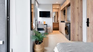Un appartement moderne comprenant un espace de vie, un coin repas et une cuisine.