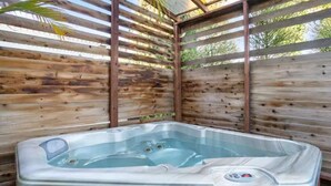 A hot tub in an outdoor wooden structure with a metal roof. - Cozy, home with hottub & patio! (Los Angeles)