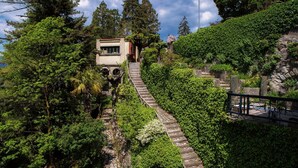 A building with a stone staircase leading up to it, surrounded by lush greenery and trees. - Fairy Tale - I Tigli - My Home In Como (Brunate)