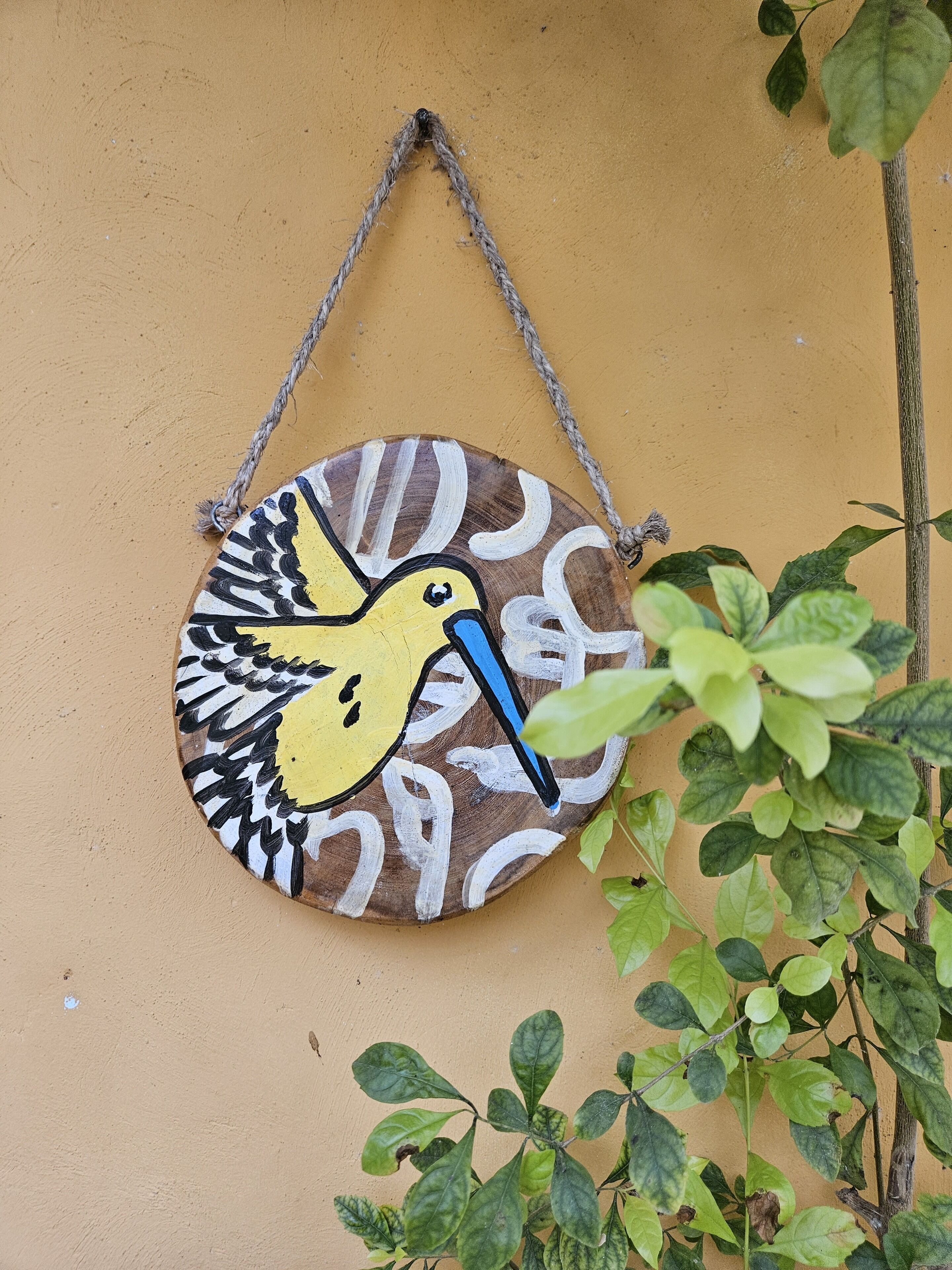 A wall-mounted decorative piece with a bird design.