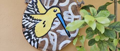 A wall-mounted decorative piece with a bird design.