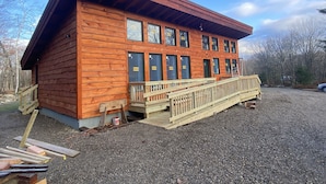 A wooden cabin with a porch and multiple windows. - Taborton Harvest
Boulder Pines
Cabin in the woods (Sand Lake)