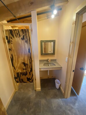 A small bathroom with a sink, mirror, and toilet. - Taborton Harvest
Boulder Pines
Cabin in the woods (Sand Lake)