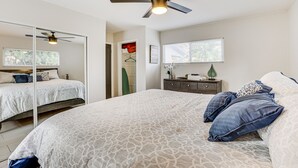 A bedroom with a large bed, a ceiling fan, a dresser, and a window. - 5 Mi to Dtwn: Pet-Friendly Phoenix Gem w/ Patio (Phoenix)