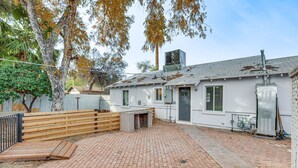 A residential property with a brick patio, a wooden fence, and a white house with a chimney. - 5 Mi to Dtwn: Pet-Friendly Phoenix Gem w/ Patio (Phoenix)