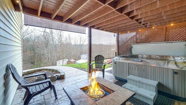 An outdoor patio with a fire pit, seating, and a hot tub. - Beckley Studio w/ Private Hot Tub & Home Gym! (Beckley)