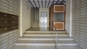 A staircase leading to a door, with patterned walls and a metal railing. - Purpo in Cattolica With 1 Bedrooms and 1 Bathrooms (Cattolica)