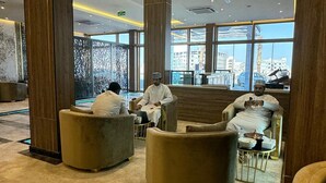 A spacious lobby with high ceilings, large windows, and modern seating areas. - Royal Plaza Hotel - Duqm  (Duqm)