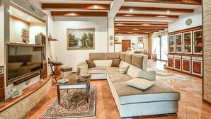 A living room with a sectional sofa, a television, and a fireplace. - Gorgeous home in Realmonte with WiFi (Realmonte)