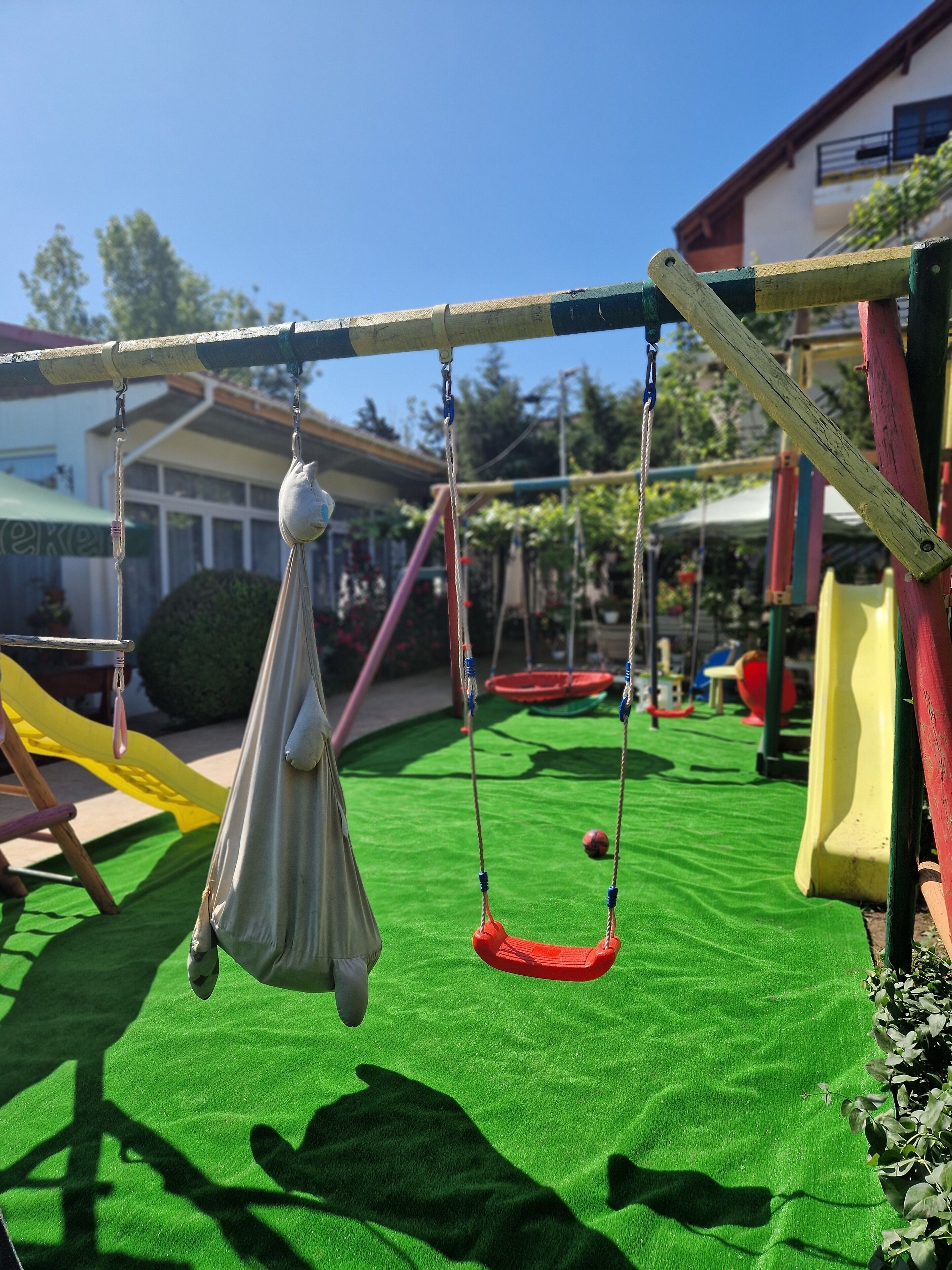 A playground with swings and a slide.