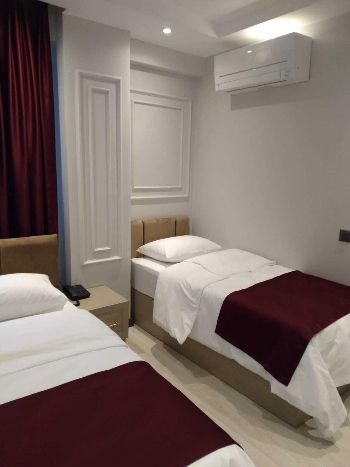 Standard Triple Room | Minibar, in-room safe, soundproofing, iron/ironing board