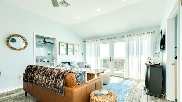A bedroom with a bed, a ceiling fan, a window with curtains, and a view of the outdoors. - Cape Allswell - Life is Good, Sun, Sand & Surf! (Freeport)