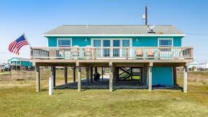 A two-story house with a balcony, a flag, and a garage. - Cape Allswell - Life is Good, Sun, Sand & Surf! (Freeport)