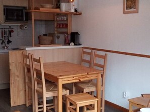 Enjoy cooking in this well-equipped kitchen with a microwave, table, and chairs.