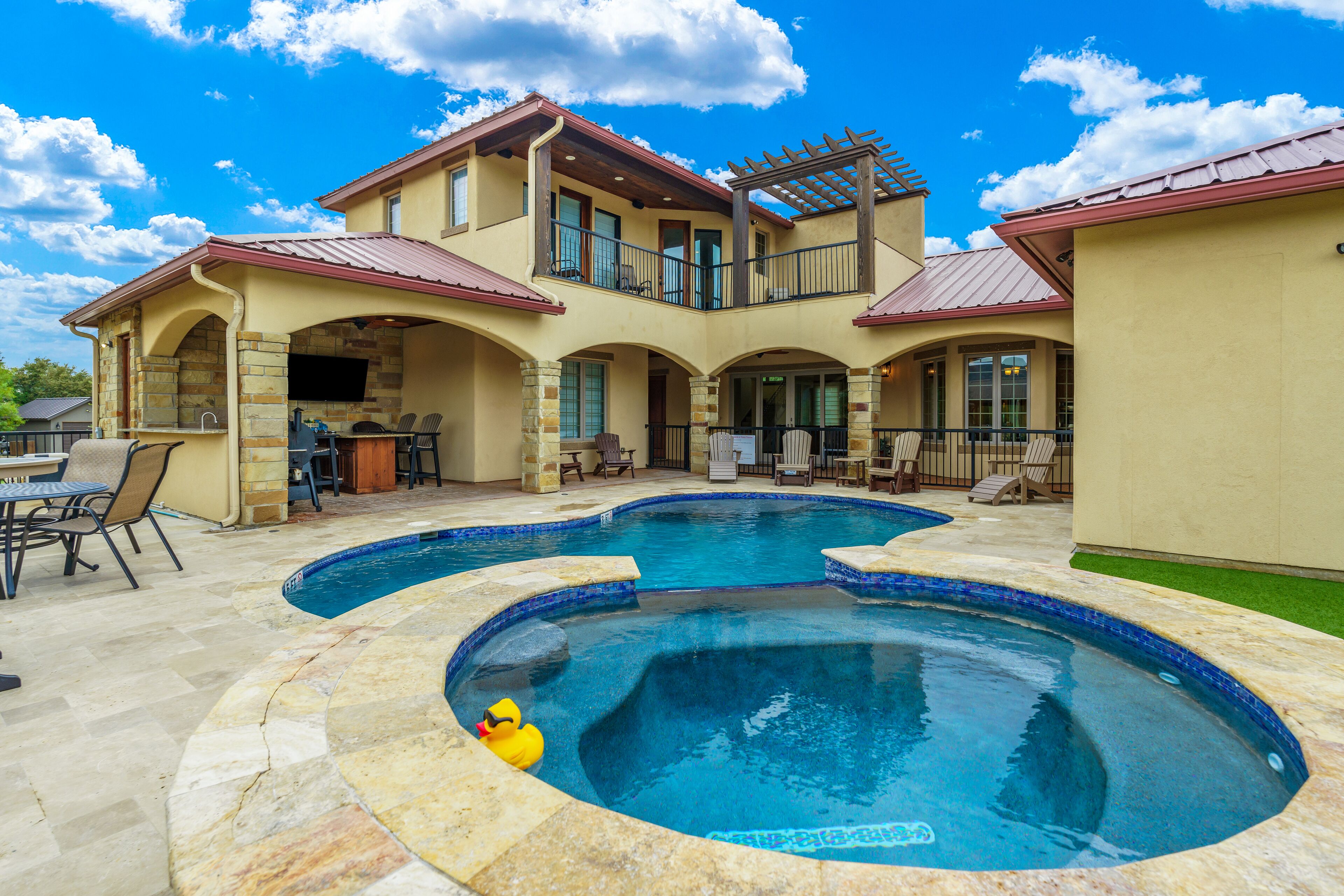 Elegant golf course home with swimming pool, hot tub, outdoor kitchen and pellet grill