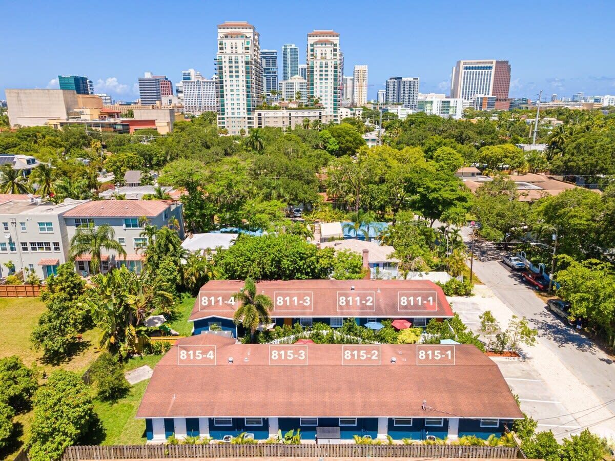 A hotel with numbered rooms and a city skyline in the background.