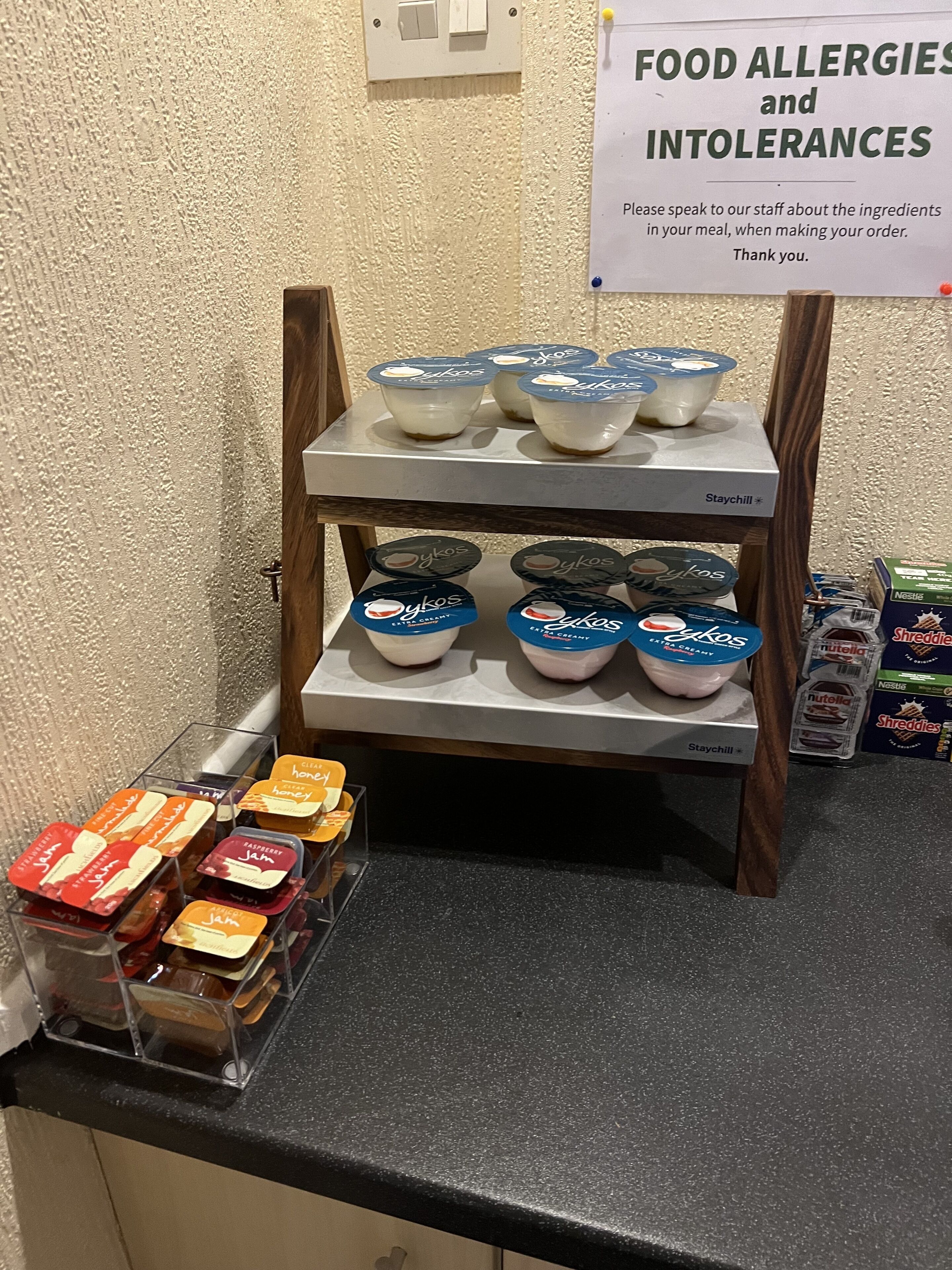 A food display with various dairy products and jams.