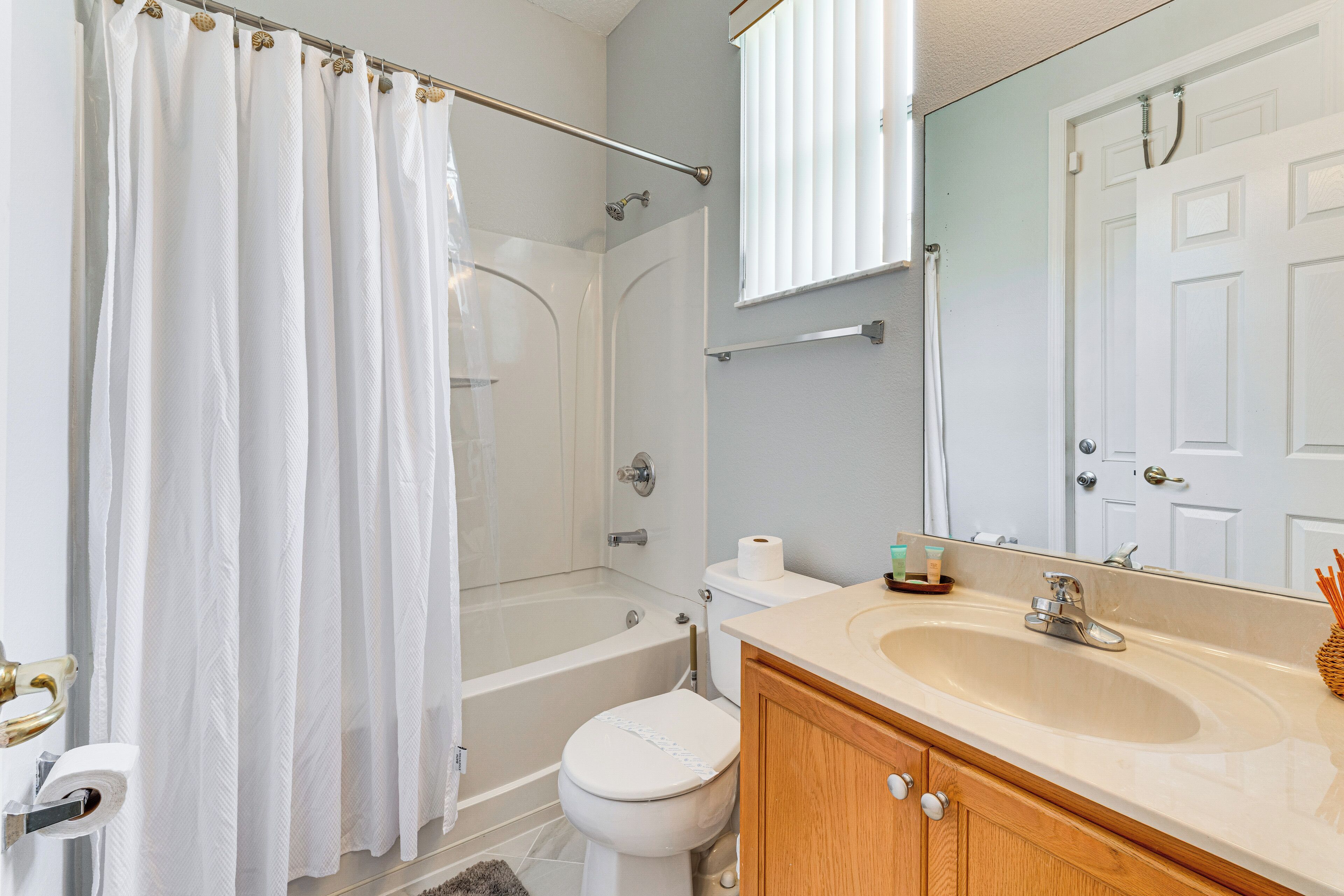 A bathroom with a bathtub, toilet, and sink.