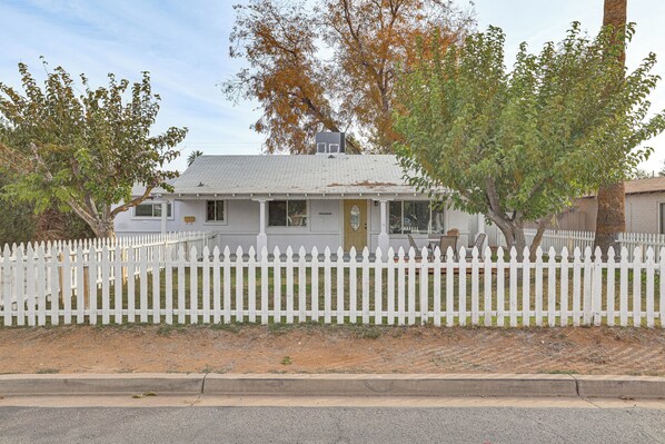 A white house with a picket fence, a garage, and a tree in front. - 5 Mi to Dtwn: Pet-friendly Phoenix Gem w/ Patio (Phoenix)