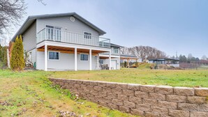 A two-story house with a covered porch and a stone retaining wall. - East Wenatchee Home ~ 2 Mi to Columbia River! (East Wenatchee)