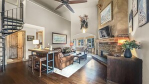 A spacious living room with a fireplace, a dining area, and a staircase leading to an upper level. - Be410 Bridge End Pet Friendly 3 Bedroom Condo by RedAwning (Copper Mountain)