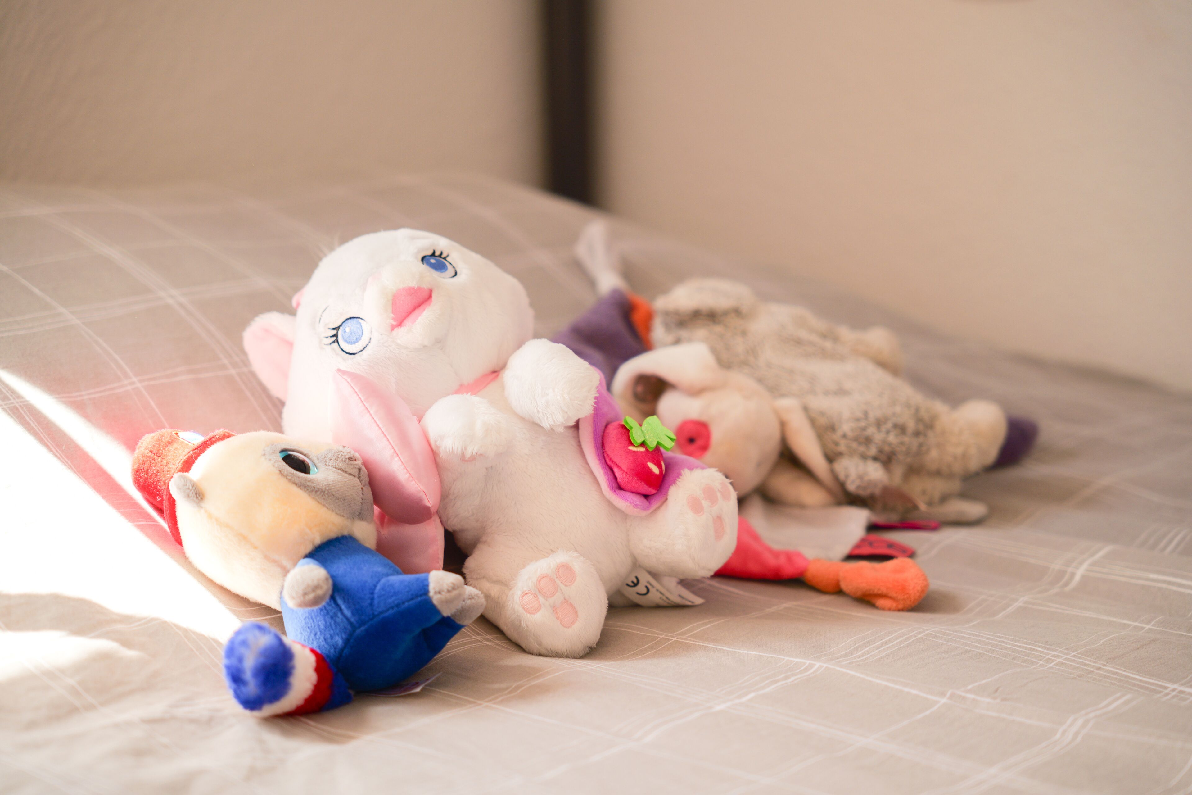 A bed with plush toys arranged on it.