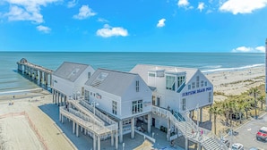 A beachfront hotel with a pier extending into the ocean, multiple balconies, and a sign reading "SURFSIDE BEACH HOTEL". - Beach Haven 1147, Short walk to the Beach Discounted weeks Book Now! (Myrtle Beach)