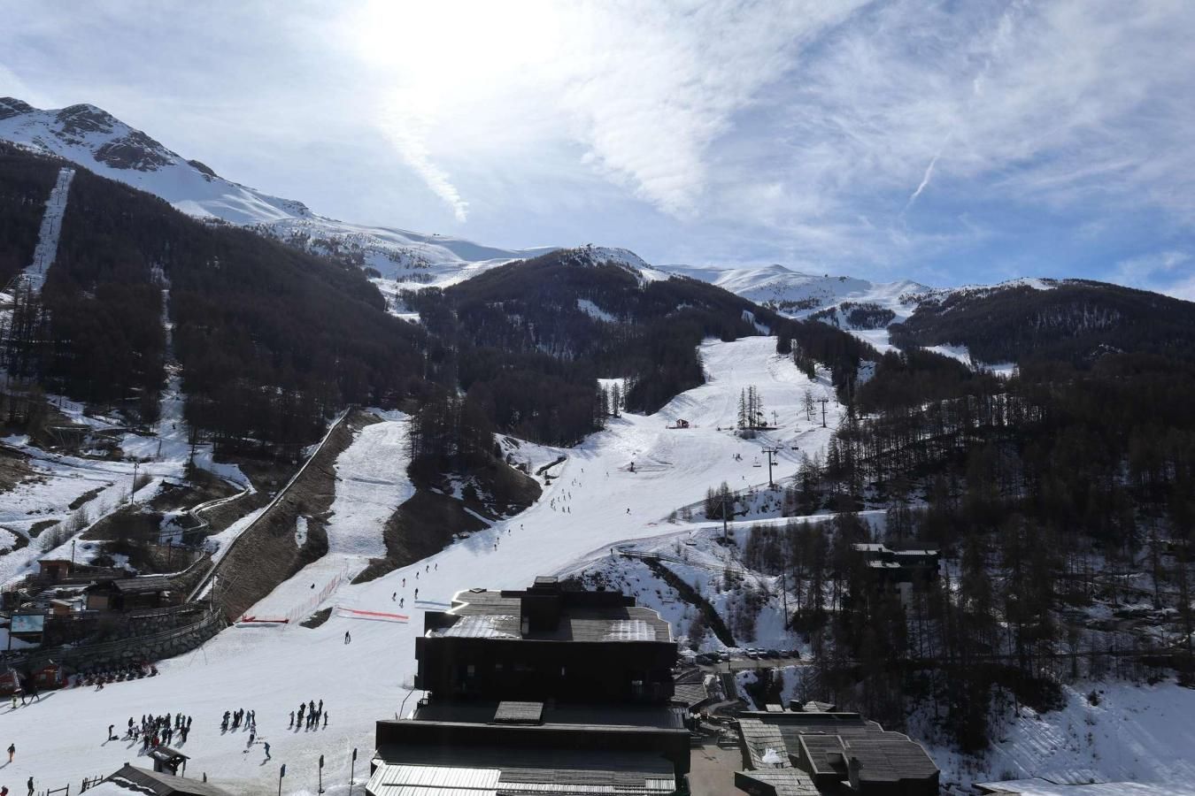 A ski resort with a chairlift, ski slopes, and mountainous terrain.