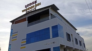 A multi-story building with a sign reading "Lodge Wonder Inn." - Wonder Inn Lodge (Ramanagara)