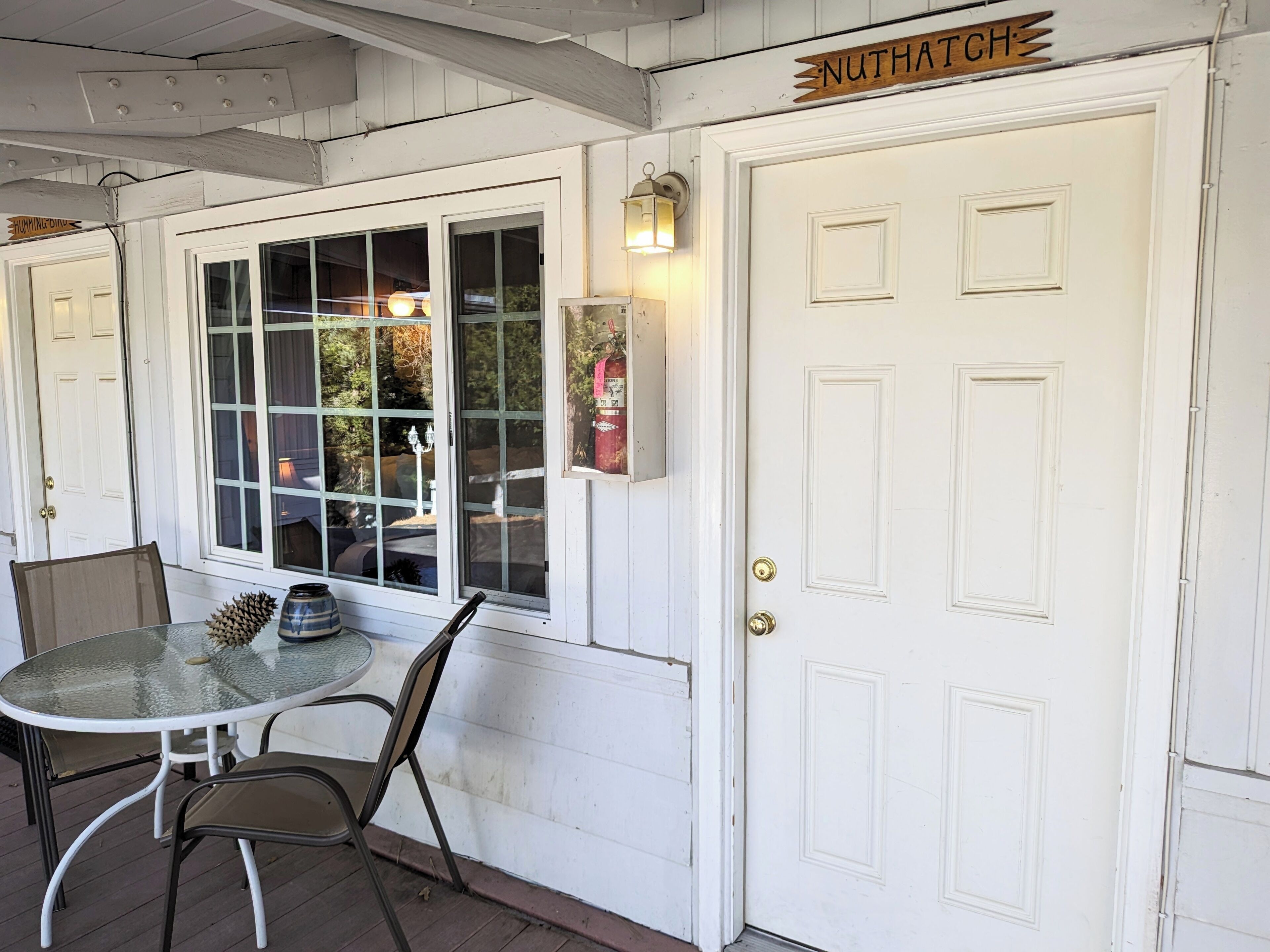 A white door with a sign reading "NUTHATCH" above it.