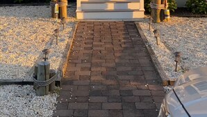 A two-story house with a brick exterior, a front porch, and a gravel driveway. - Summer Special June 20-27, July 6-11, July 25-Aug 1. Sleeps 12 and pet friendly  (Lavallette)