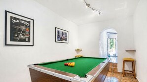 A pool table with balls, a framed Jack Daniel's poster, and a framed picture on the wall. - Villa 'Robis Moraira' with Sea View, Wi-Fi and Air Conditioning (Benissa)