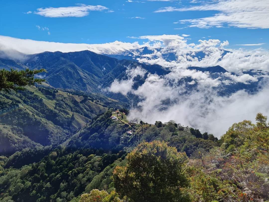 A mountainous landscape with a village nestled among the hills.