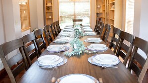 A long dining table set with plates, silverware, and a centerpiece. - Rare Super Host - Arcade w/ 5 Kings, Hot Tub, Pub (Inver Grove Heights)