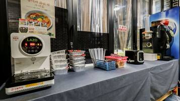 A coffee machine, stacked trays, and a menu on a table.