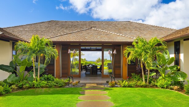 A house with a tiled roof, a covered patio, and a well-maintained lawn with stepping stones leading to the entrance. - Hale Kipu by Alekona Kauai: Luxury 5br Ocean View Home w Pool, Fire pit, Spa (Koloa)
