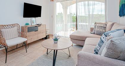 Modern condo near beaches with mountain views, outdoor pool, balcony, W/D, AC